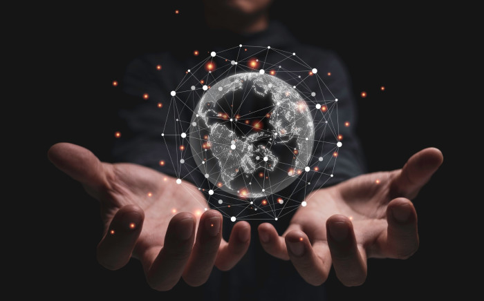 image of man holding digital globe